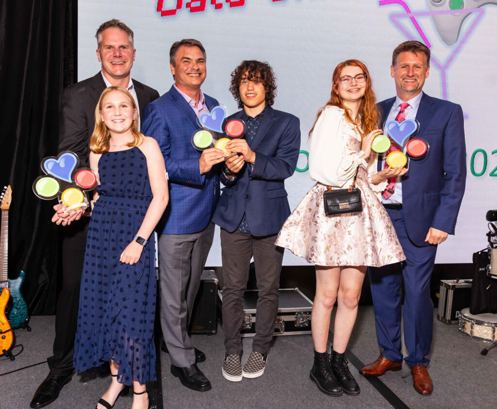 The honorees posing with their kids.