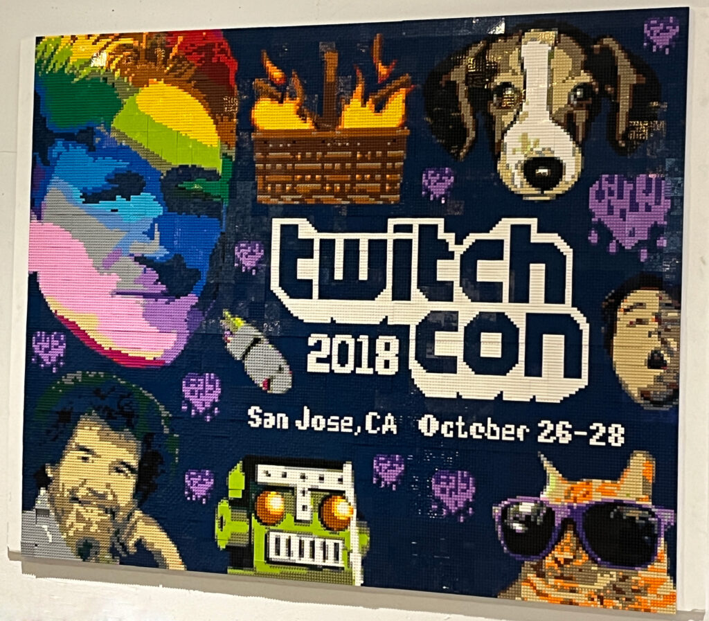 Lego art of TwitchCon 2018 logo and various emoji.