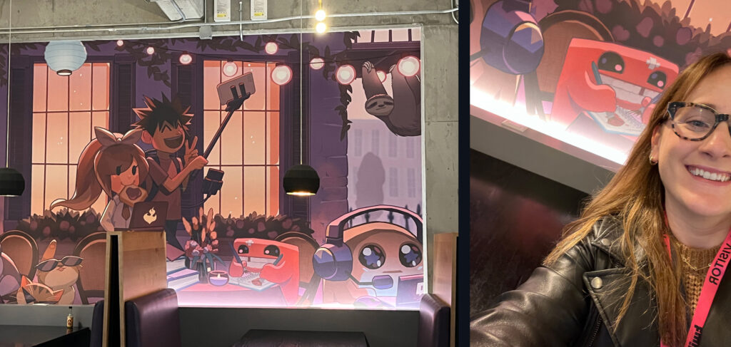 Mural on the cafeteria wall featuring Meat Boy and other game characters, next to a selfie of Monique in next to Meat Boy.